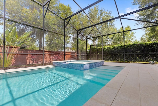 view of swimming pool with glass enclosure and an in ground hot tub