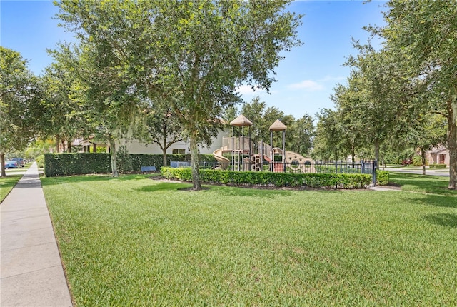 view of community with a playground and a lawn