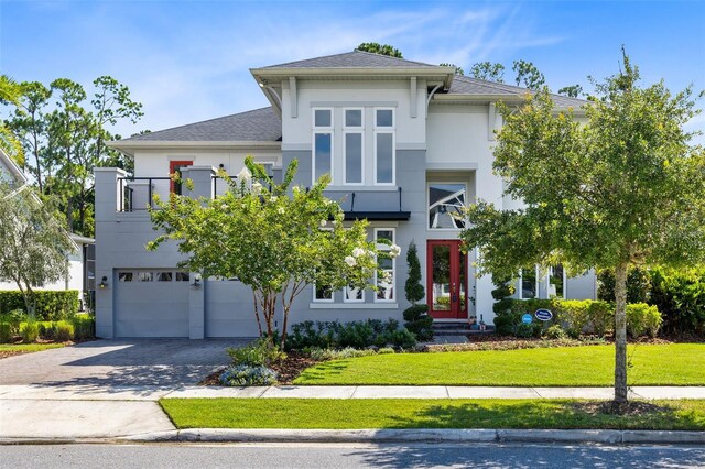 view of front of property with a garage and a front lawn