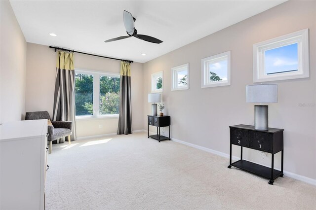 interior space with light colored carpet and ceiling fan