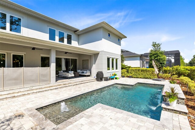 back of house with a fenced in pool, a lanai, ceiling fan, a patio, and pool water feature