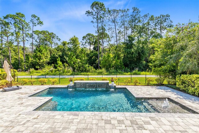 view of swimming pool featuring pool water feature and a patio area