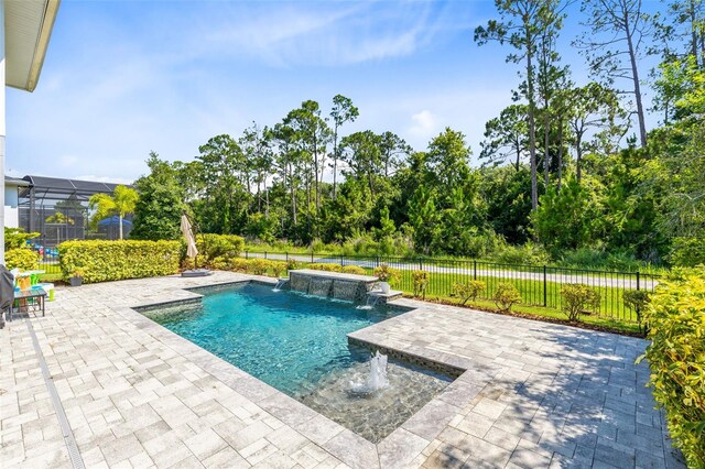 view of pool featuring a lanai, pool water feature, and a patio area