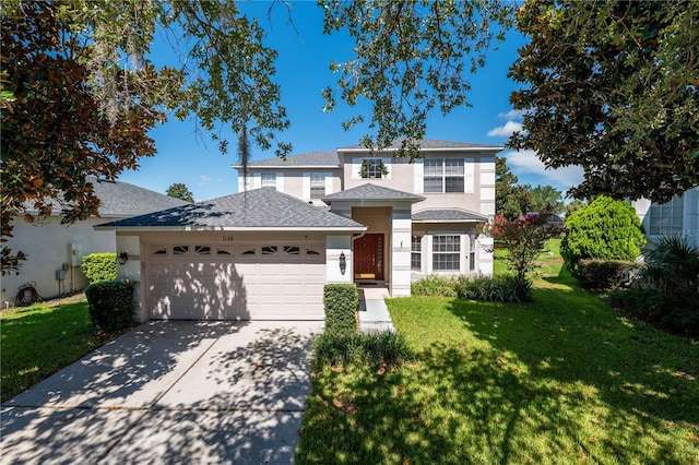 view of front of home featuring a front yard and a garage