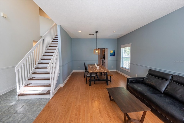 living room with hardwood / wood-style floors and a textured ceiling