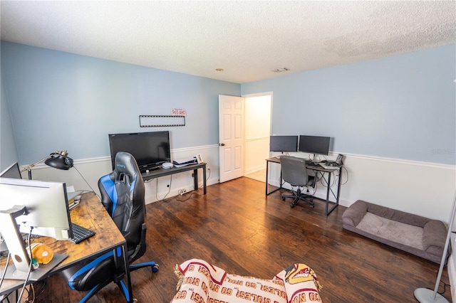 office with a textured ceiling and dark hardwood / wood-style floors