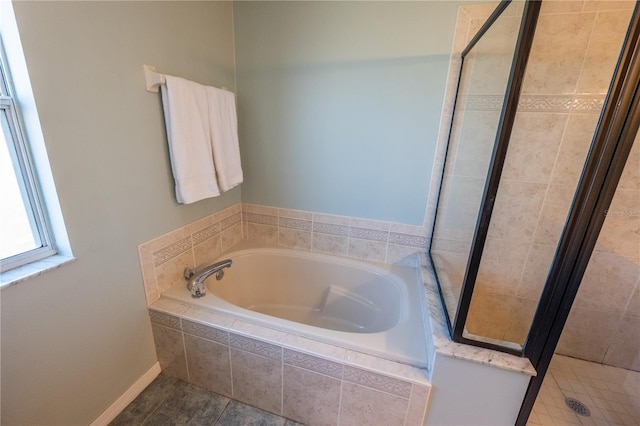 bathroom with plus walk in shower and tile patterned flooring