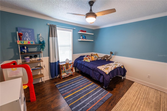 bedroom featuring a textured ceiling, ceiling fan, dark hardwood / wood-style floors, and ornamental molding