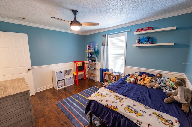 bedroom with a textured ceiling, dark hardwood / wood-style floors, ceiling fan, and ornamental molding