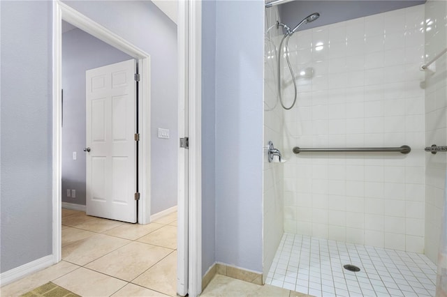 bathroom featuring tile patterned flooring and a tile shower