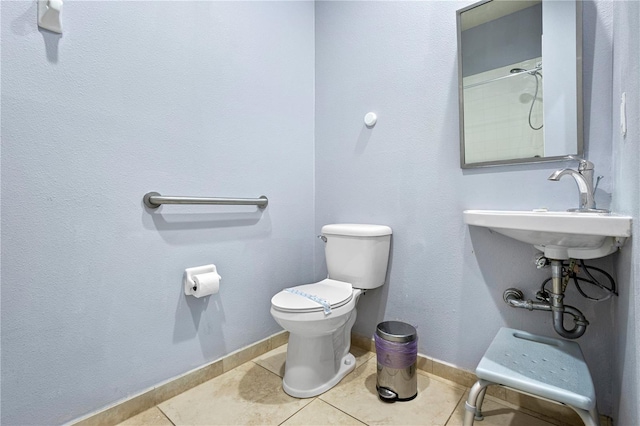 bathroom featuring tile patterned floors, toilet, and sink