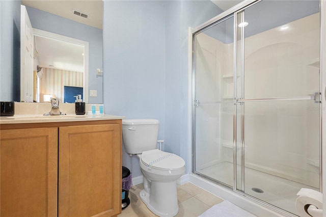 bathroom featuring tile patterned floors, vanity, toilet, and walk in shower