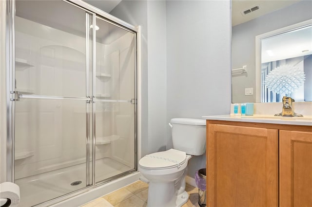 bathroom featuring tile patterned floors, toilet, an enclosed shower, and vanity