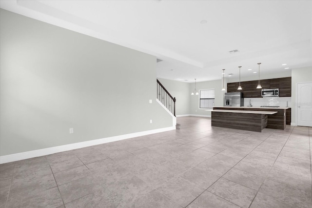 unfurnished living room with light tile patterned flooring