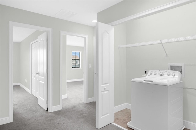 laundry area with washer / dryer and light colored carpet