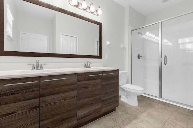 bathroom with vanity, toilet, and a shower with shower door