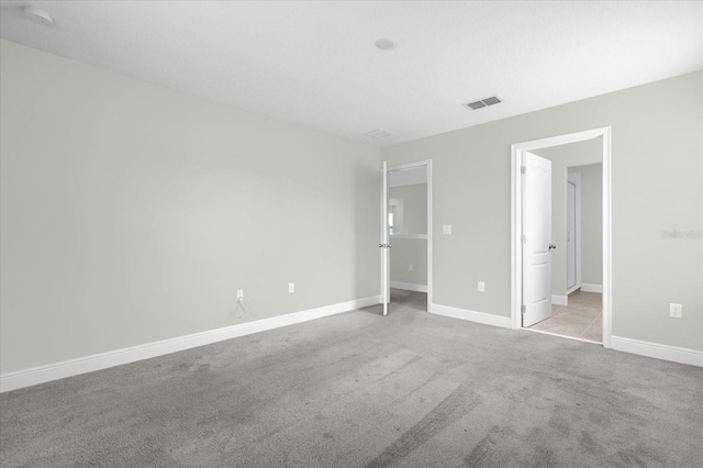 unfurnished bedroom featuring light carpet