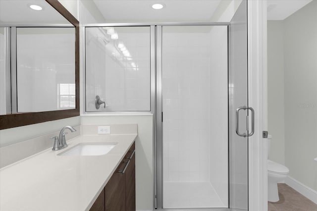 bathroom with tile patterned flooring, vanity, toilet, and an enclosed shower