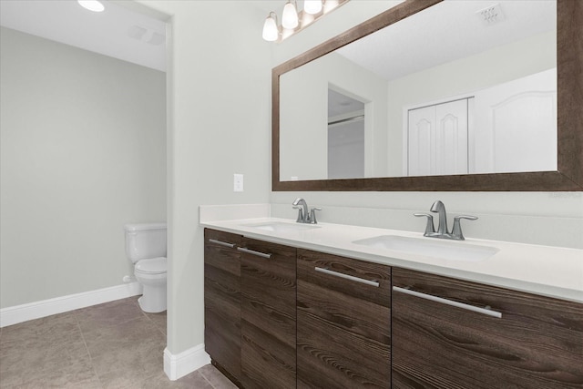 bathroom featuring tile patterned flooring, vanity, and toilet