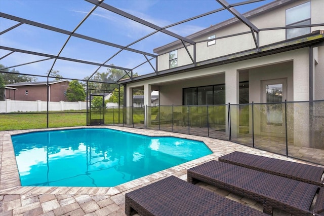 view of pool with a lawn, glass enclosure, and a patio area