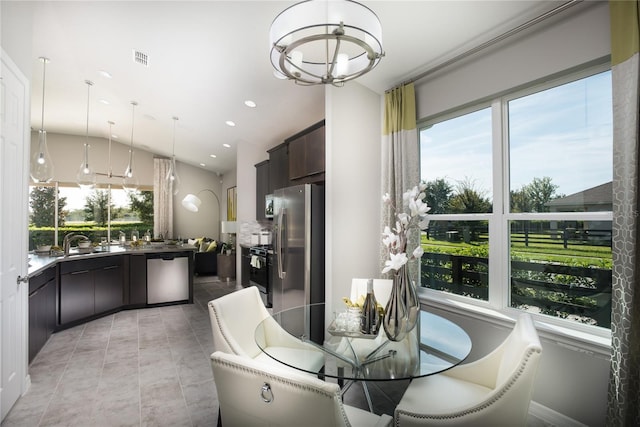 tiled dining space featuring sink and a chandelier