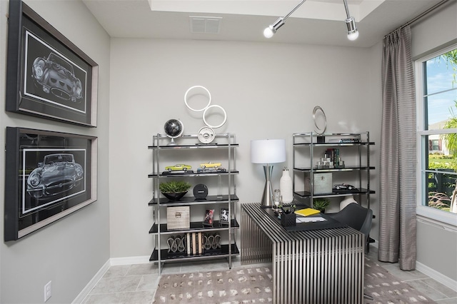 tiled office featuring track lighting