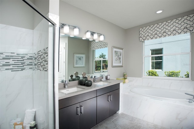 bathroom featuring shower with separate bathtub and vanity