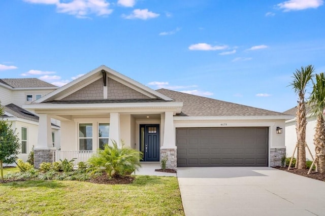 craftsman-style home with a garage, a front lawn, and covered porch