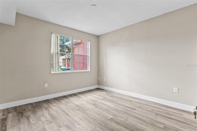 empty room with light hardwood / wood-style floors