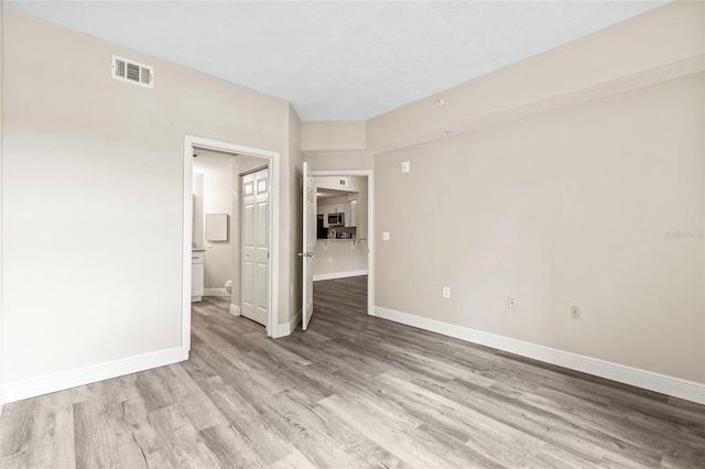 empty room with light hardwood / wood-style floors