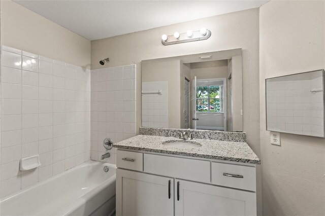 bathroom with vanity and tiled shower / bath combo