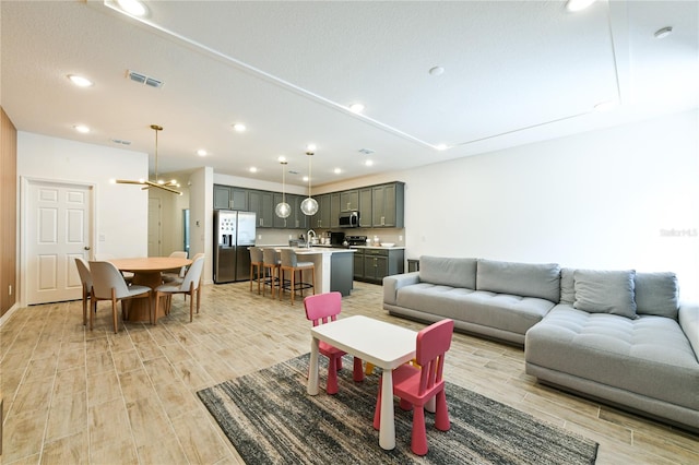 living room featuring sink and light hardwood / wood-style floors