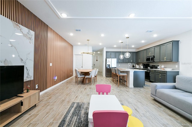 living room with sink and wood walls