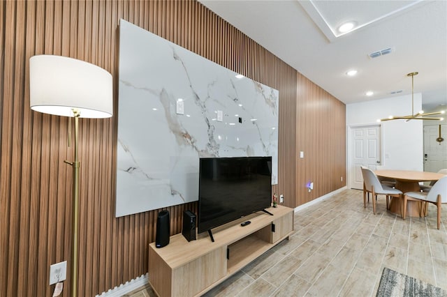 living room with a chandelier and light wood-type flooring