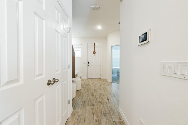 corridor with light hardwood / wood-style flooring