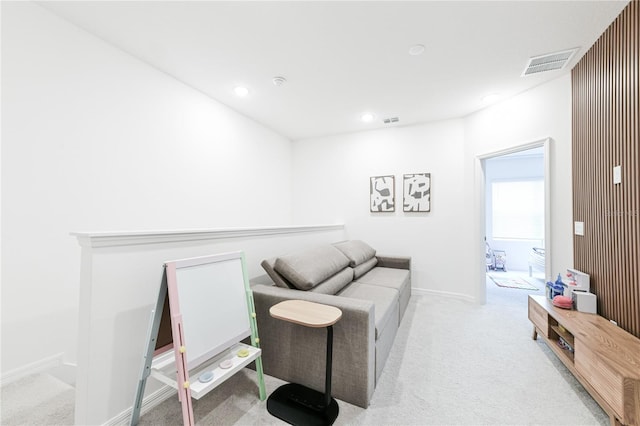 sitting room featuring light colored carpet