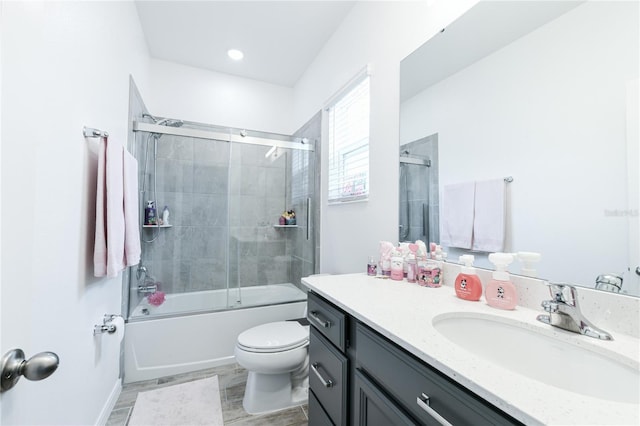 full bathroom featuring shower / bath combination with glass door, vanity, toilet, and hardwood / wood-style floors