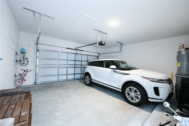 garage featuring a garage door opener and water heater