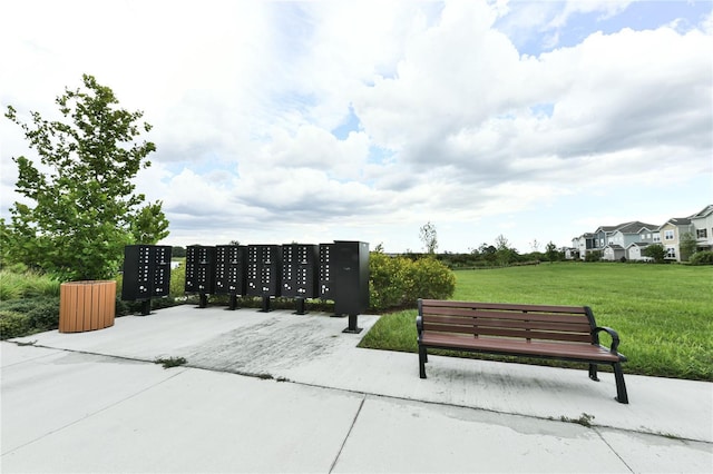 view of home's community featuring a yard and a mail area