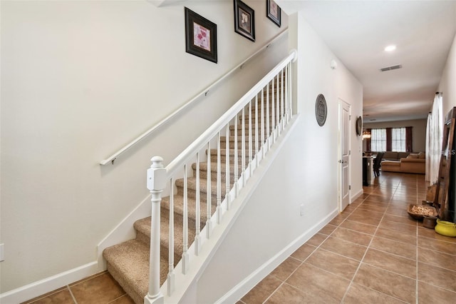 stairway featuring tile patterned floors