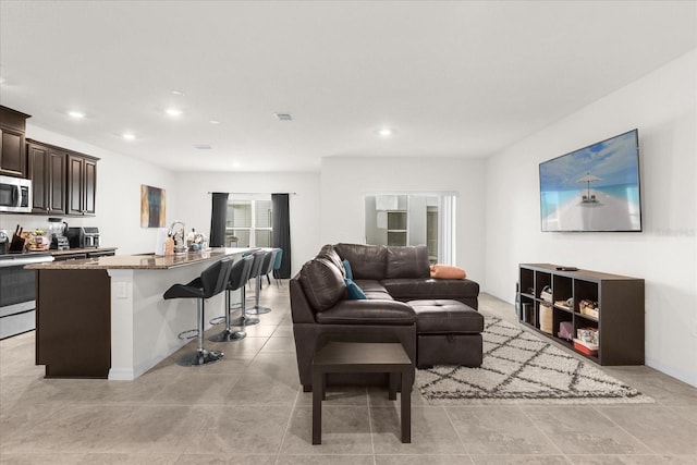 living area featuring recessed lighting, visible vents, and light tile patterned flooring