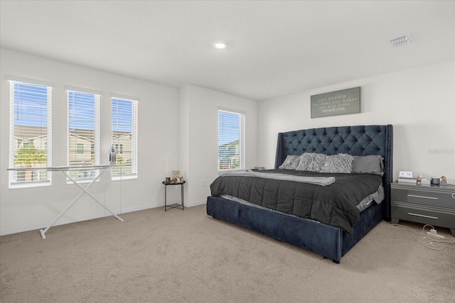 carpeted bedroom with visible vents and baseboards