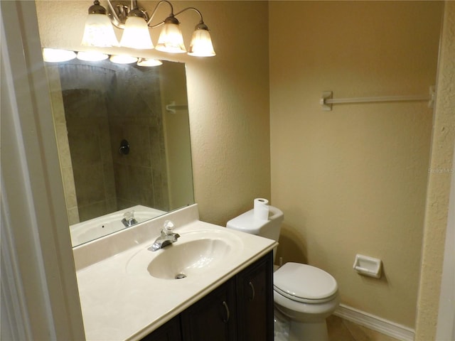 bathroom with toilet, vanity, and an inviting chandelier