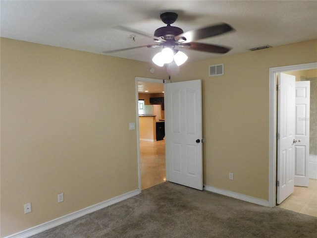 unfurnished bedroom featuring ceiling fan and light colored carpet