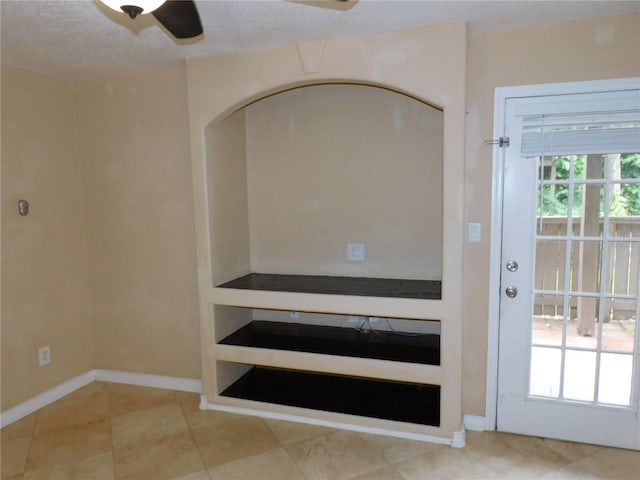 interior space featuring ceiling fan and tile patterned floors