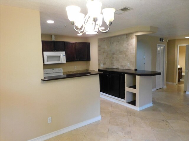 kitchen featuring range, dark brown cabinets, decorative light fixtures, light tile patterned floors, and kitchen peninsula