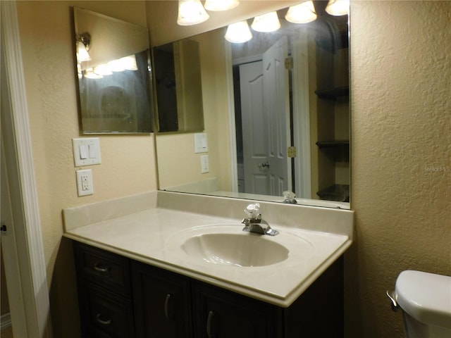 bathroom with toilet and vanity