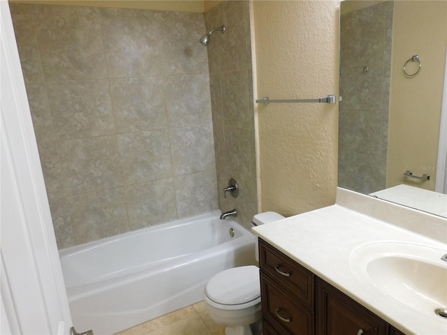 full bathroom featuring tiled shower / bath combo, vanity, toilet, and tile patterned floors