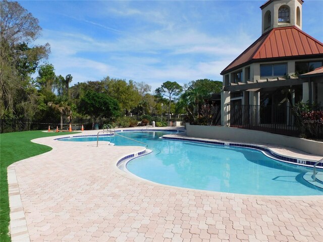 view of swimming pool with a patio