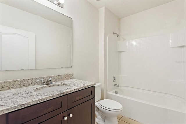 full bathroom featuring tile patterned floors, toilet, vanity, shower / bathing tub combination, and a textured ceiling